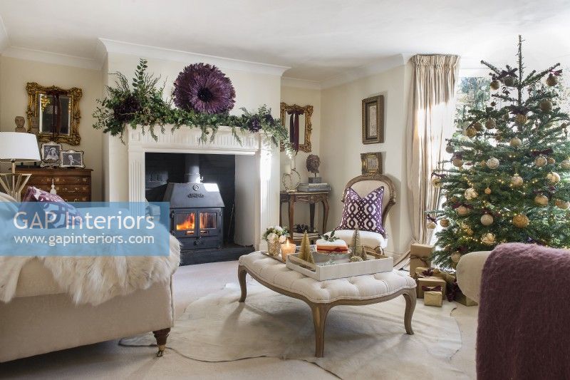 Lit fireplace in classic living room decorated for Christmas