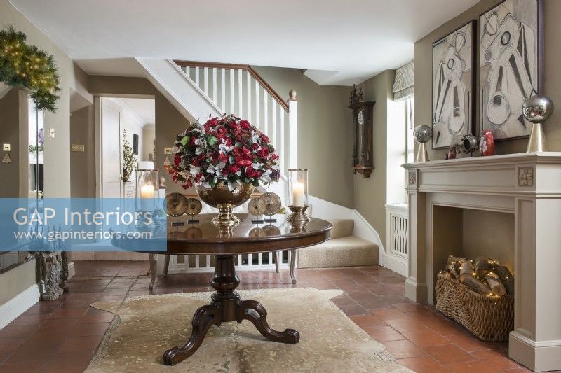 Large floral arrangement on wooden table in classic hallway