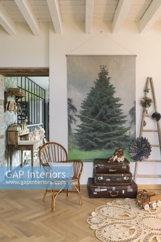 Old suitcases and Christmas tree painting in country living room
