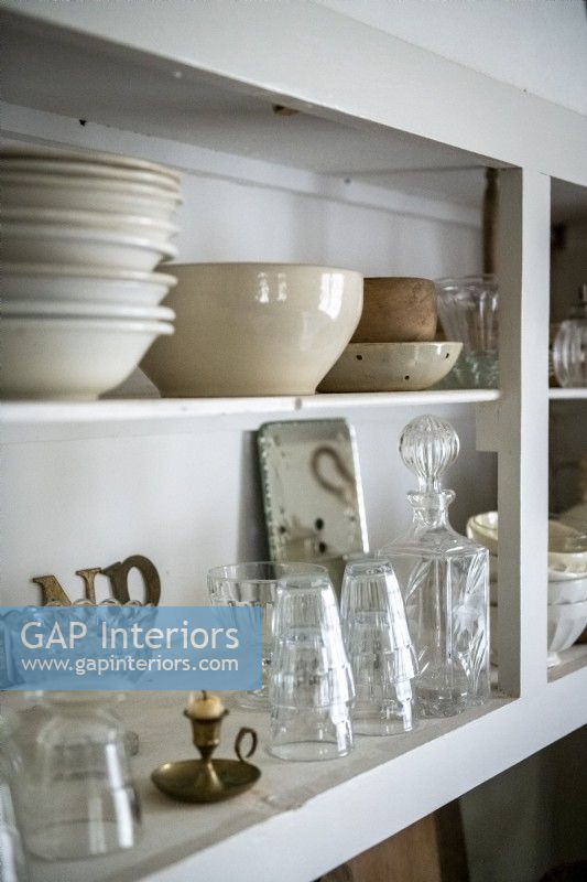 Open cupboard shelving in country kitchen - crockery and glassware