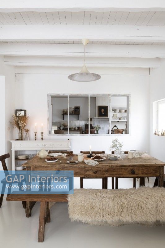 Old wooden table in white country dining room 