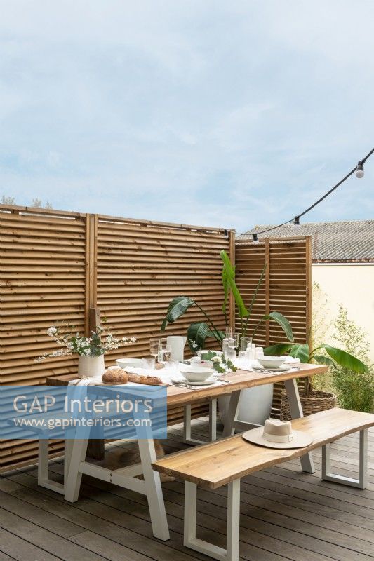 Modern picnic table on terrace with fence privacy screening