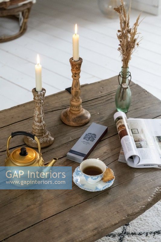 Candles on rustic wooden coffee table - detail