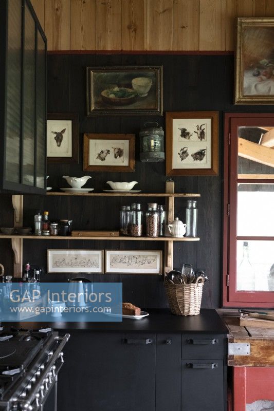 Black painted walls and cabinets in country kitchen