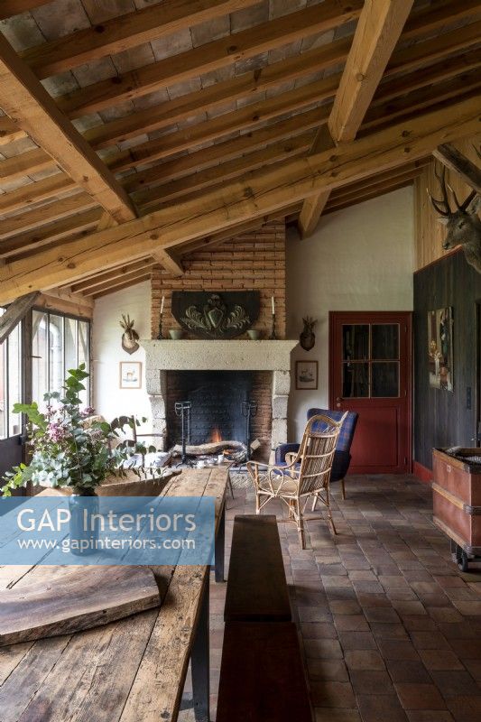 Country dining room with lit fireplace