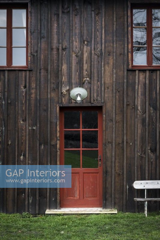 Red door in wooden country house - exterior