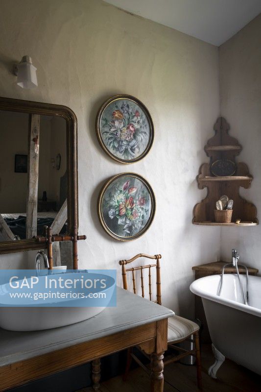 Floral paintings on wall of country bathroom