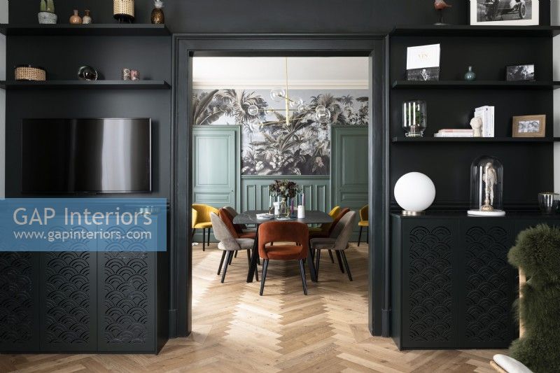View into modern dining room thorugh black painted doorway