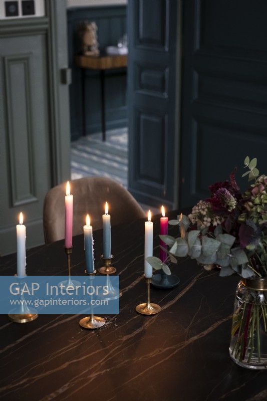 Lit candles on dining table - detail