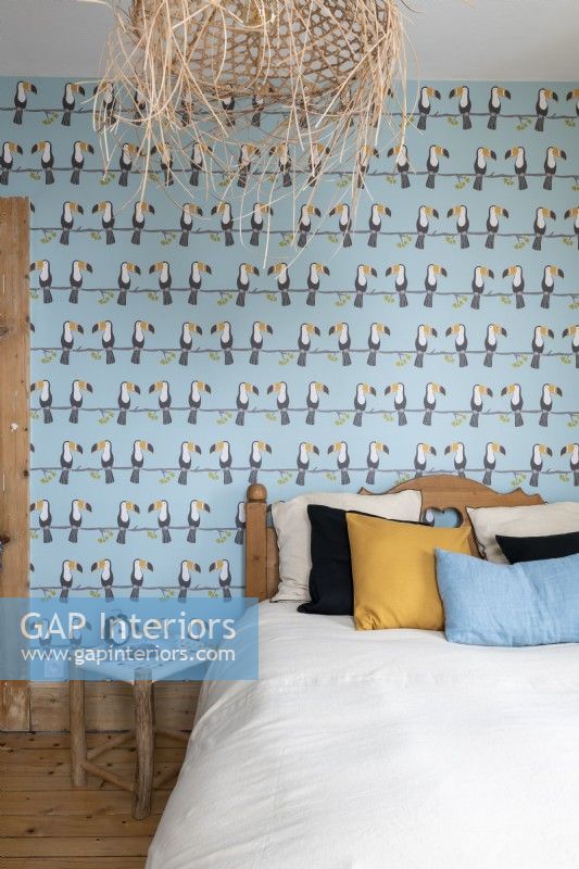 Toucan patterned wallpaper in modern bedroom