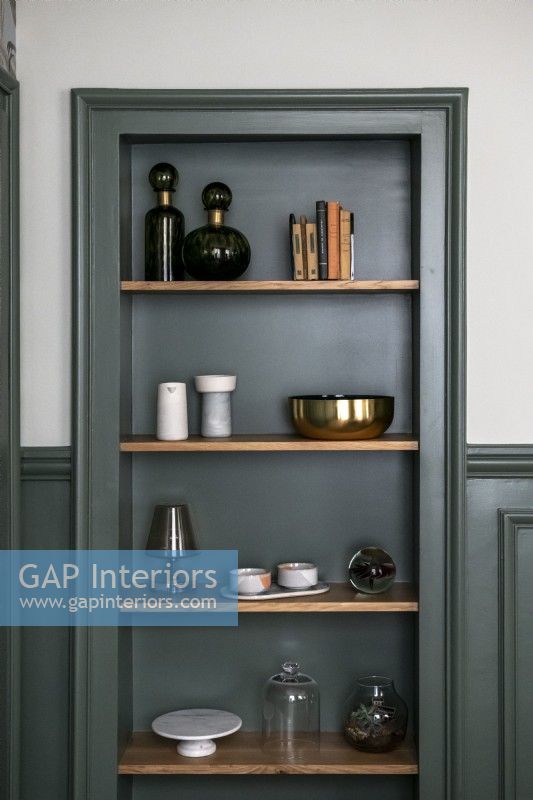 Dark green painted woodwork - shelving in alcove