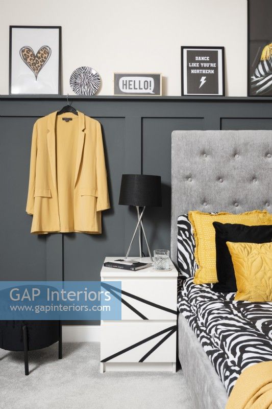 Monochrome and yellow bedside with grey panelling