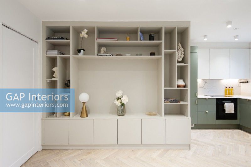 Built in shelving in open plan living space with kitchen