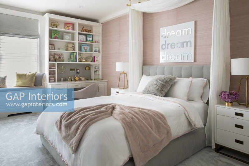 Feminine childrens bedroom in pink, white and grey.