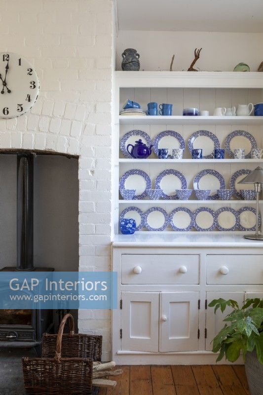 Dresser with blue and white china in white painted living room