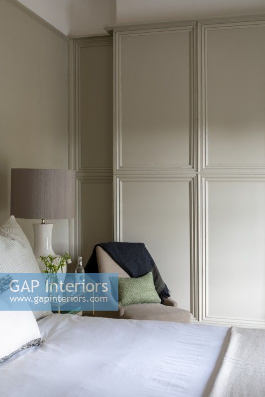 Comfortable bedroom with panelled walls