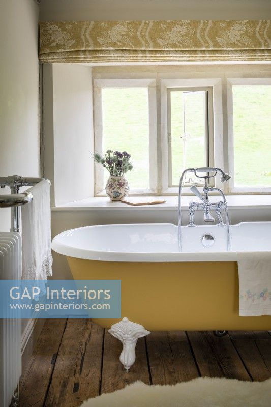 Rolled top bath in ancient stone cottage.