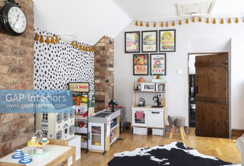 Childrens room with play kitchen and large cowhide rug