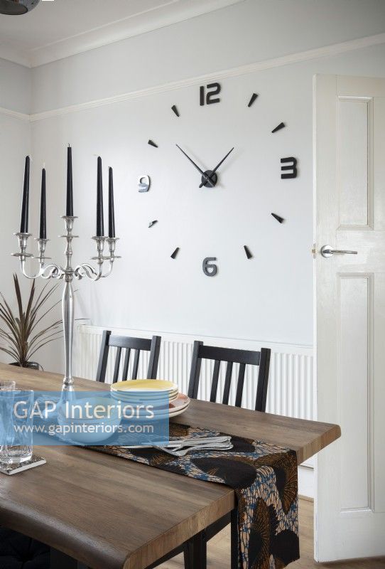 Large clock on wall of modern dining room