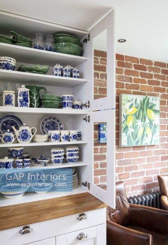 Dining room dresser filled with blue, white and green crockery