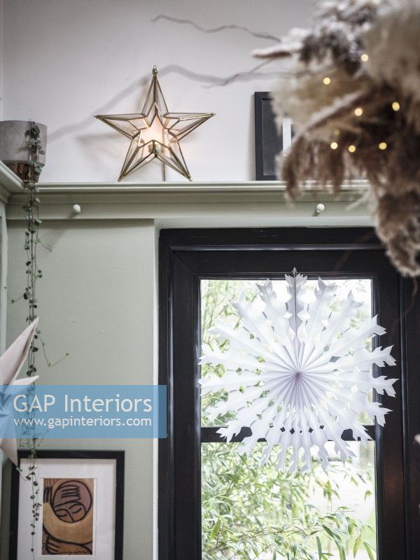 Window with paper Christmas Decoration and star