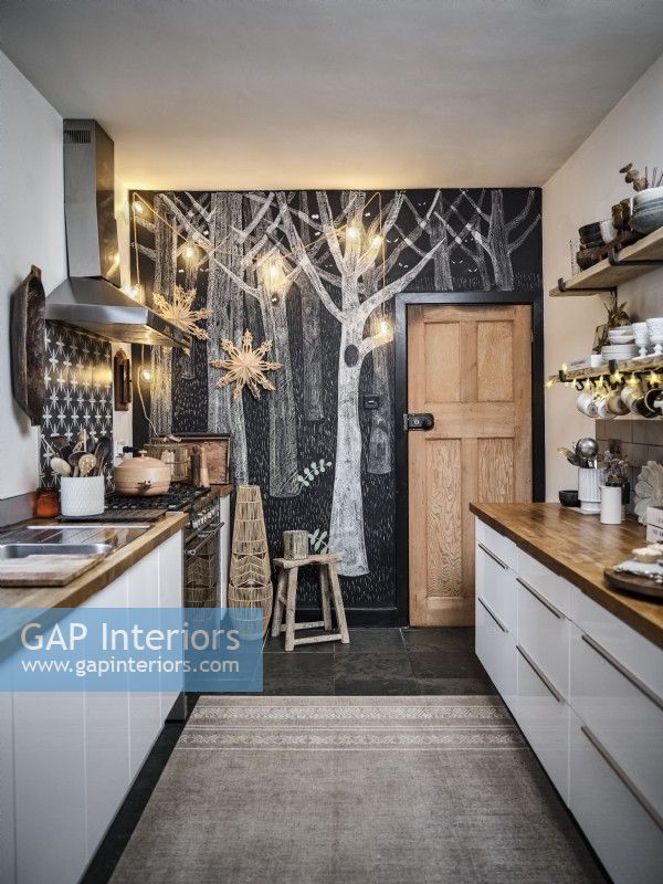 Kitchen with black and white tree chalk mural