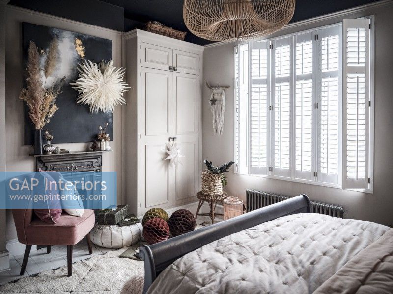Bohemian bedroom with fitted wardrobe and shutters