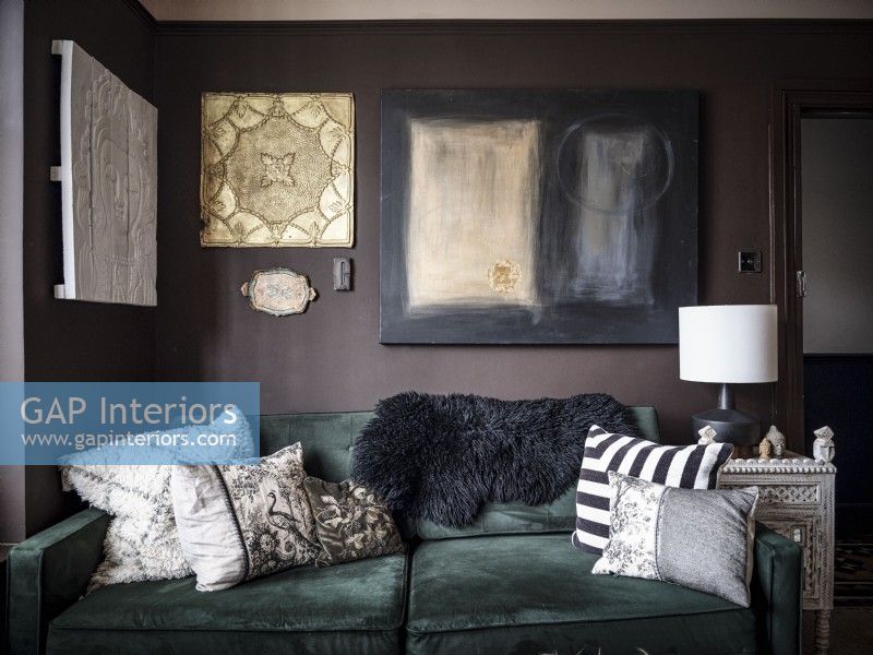Living room detail, velvet sofa with wall hung artwork