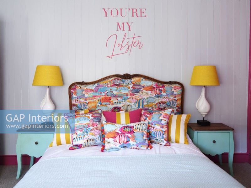 Colourful coastal bed with upholstered headboard