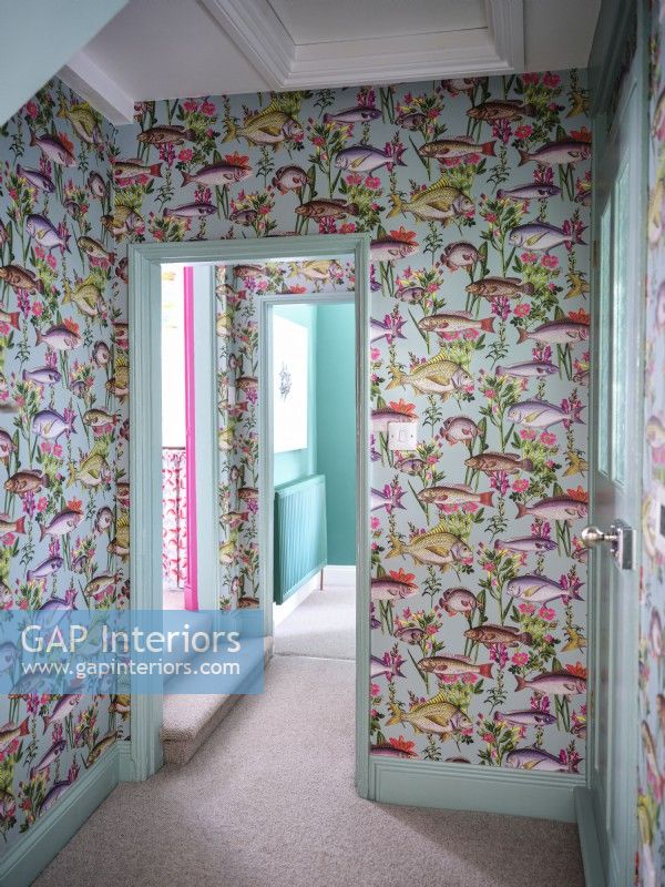 Coastal inspired corridor with fish patterned wallpaper