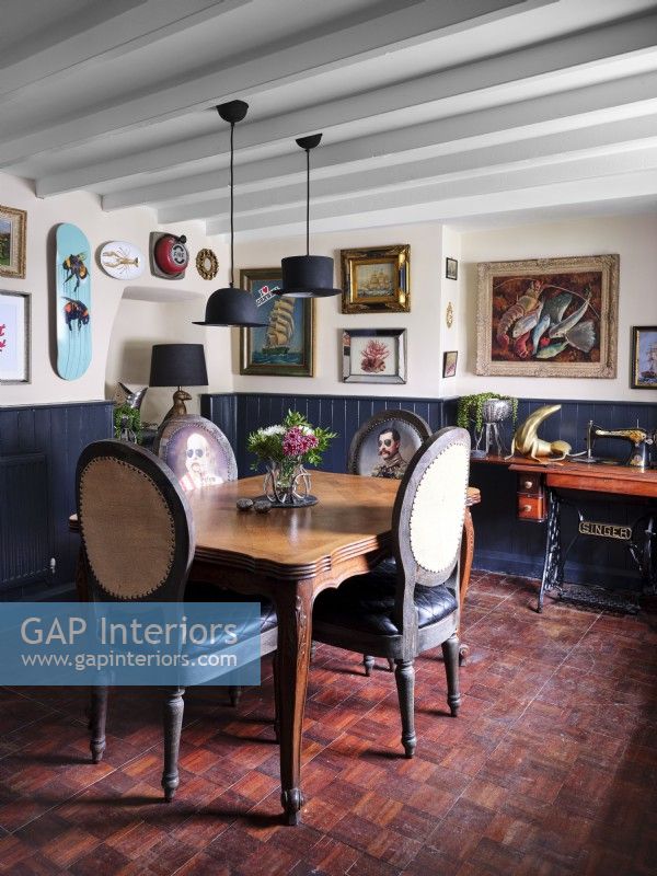 Quirky coastal themed dining room with upholstered chairs