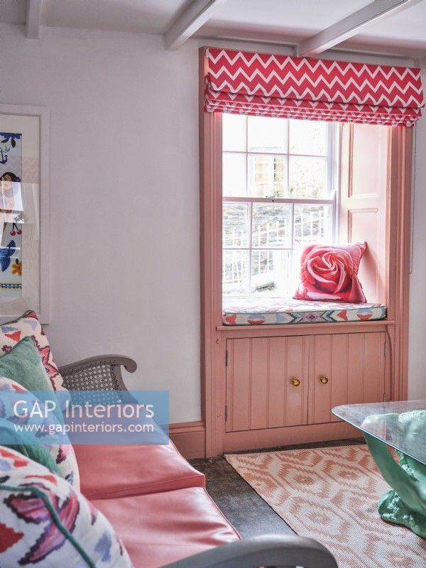 Window seat with rose cushion and blind
