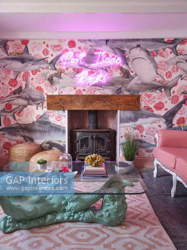 Coastal themed living room with pink furniture and fireplace