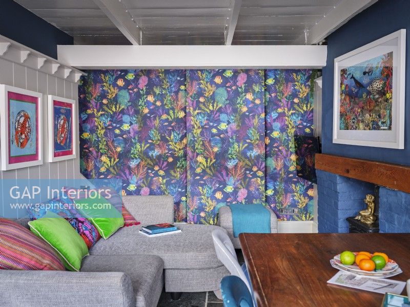 Colourful dining room with feature wall, panelled wall and marine artwork