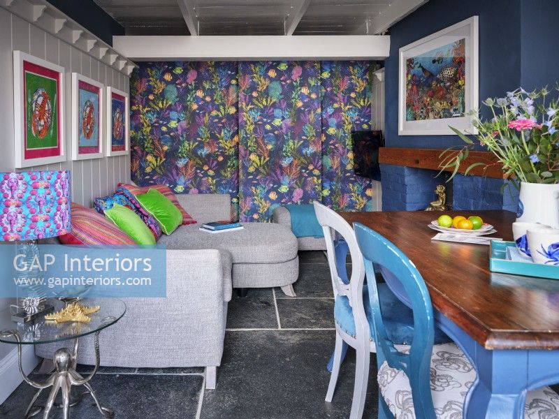 Colourful open plan dining room with coastal inspired ornaments, furnishings and artwork