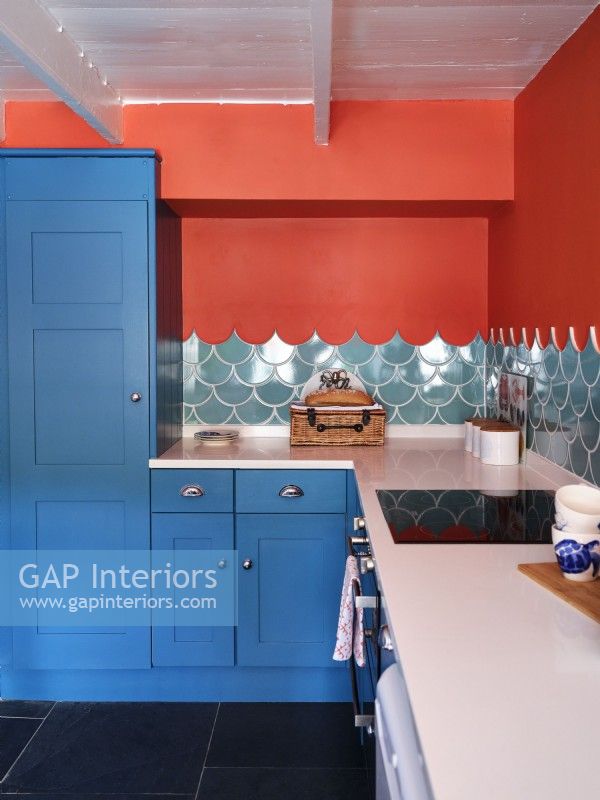 Blue units and sea inspired tiles in modern kitchen 