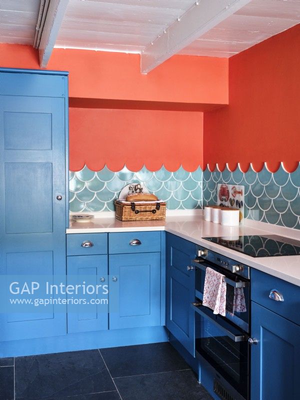 Blue kitchen units in colourful, modern kitchen
