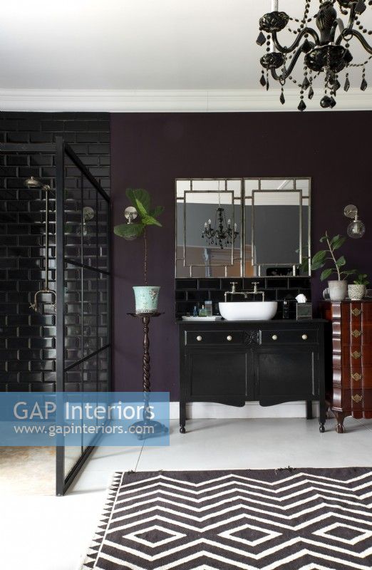 Bathroom with walk-in shower, mirrors and black vanity