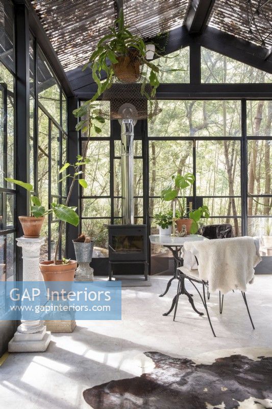 Dining area with fireplace in greenhouse