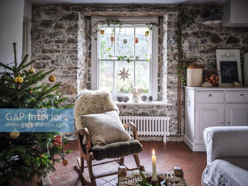 Country living room featuring rocking armchair and Christmas decorations