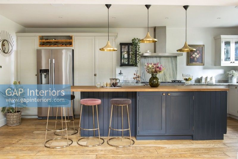 Large island with breakfast bar and barstools in modern kitchen