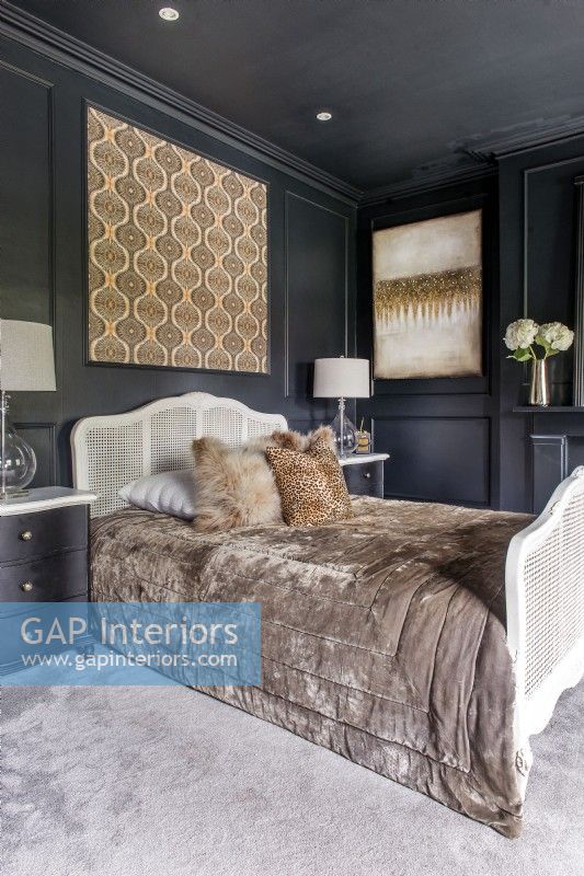 Modern black and gold bedroom with rattan bed frame