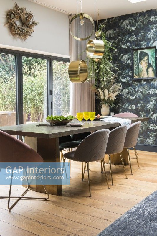 Vintage picture on patterned feature wall in modern dining room