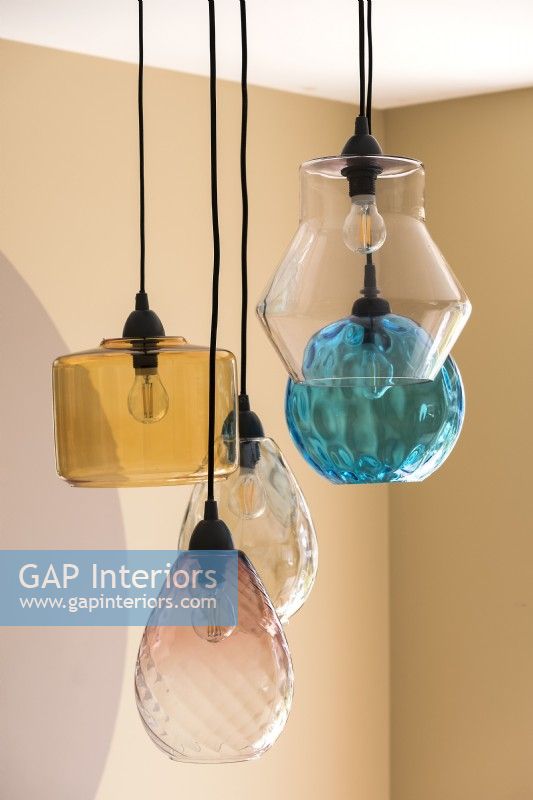 Detail of collection of glass lampshades over pendant lights 
