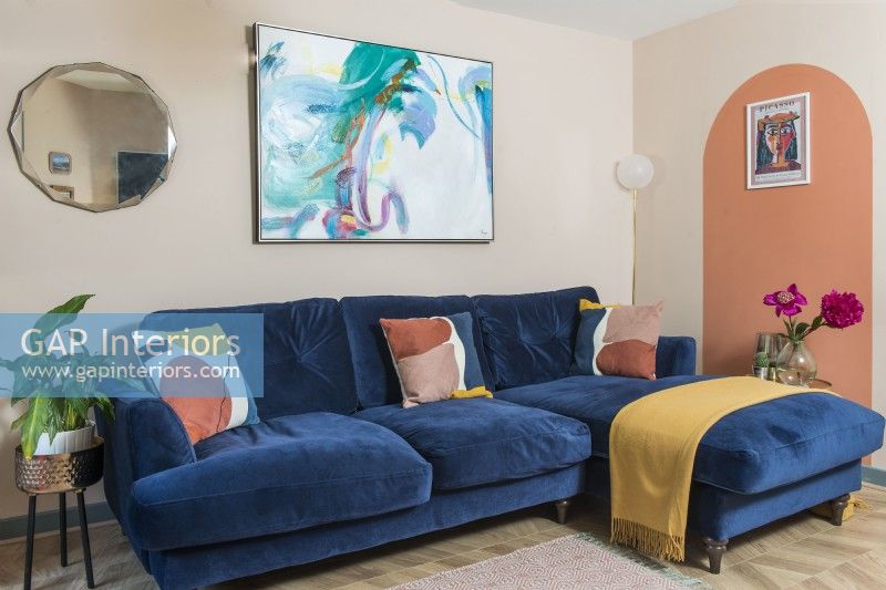 Large dark blue sofa in living room with painted walls