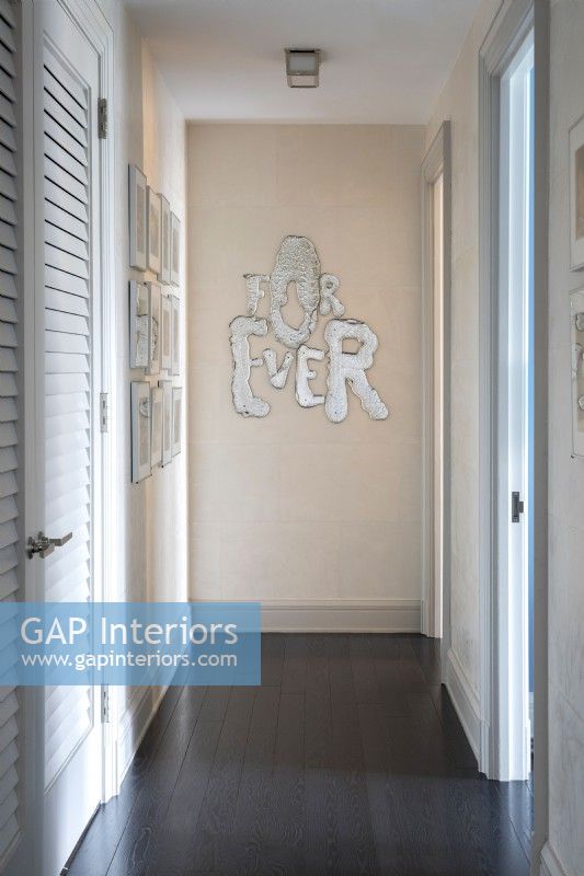 Narrow hallway decorated with For Ever sign.