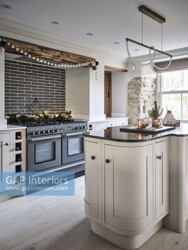 Modern kitchen with island unit, exposed brickwork and Christmas decor