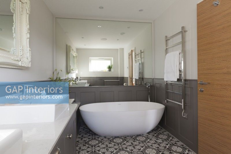 Modern bathroom with grey panelling and patterned tiles