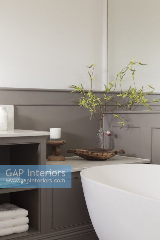 Detail of modern bathroom with grey panelling storage