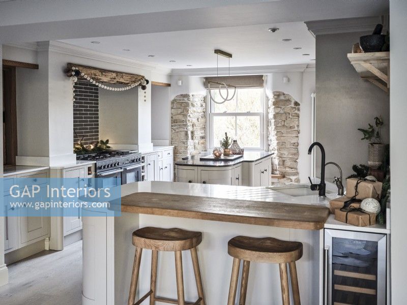 Modern kitchen featuring island unit and exposed brickwork